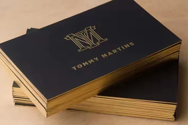 Luxury business cards with gold borders, showcasing premium printing.