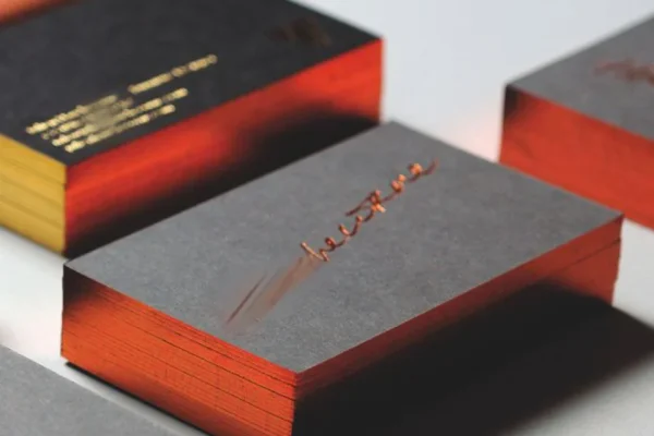 Luxury black business cards with red edges and hot stamp design.