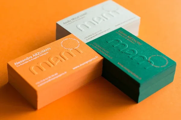 Colourful embossed business cards for professional branding.