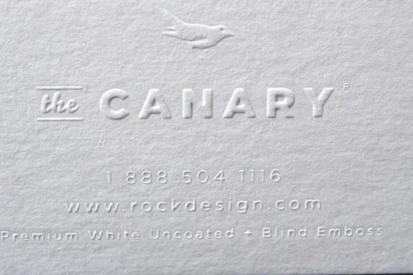 Embossed business card with blind embossing and uncoated white paper.