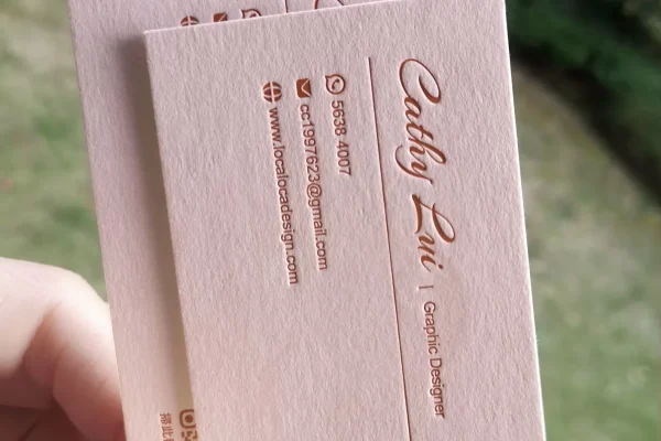 Embossed business card with custom logo and contact details.