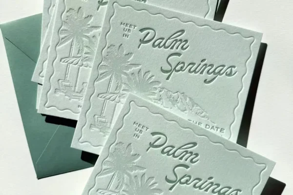 Elegant wedding invitations with embossed Palm Springs design.