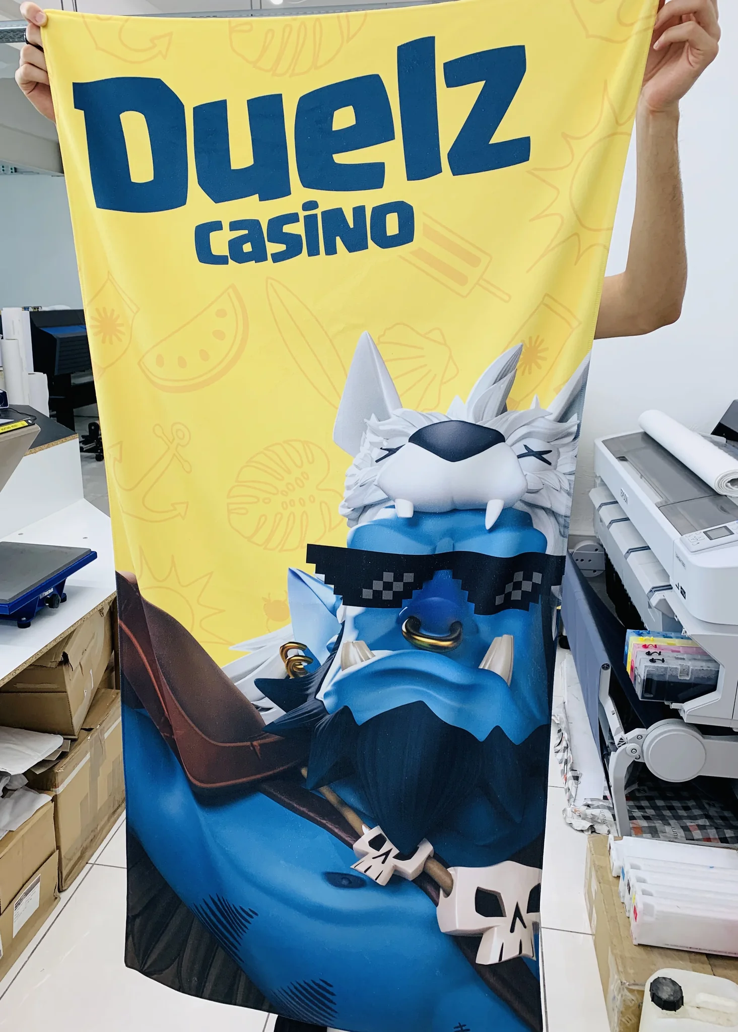 Custom printed towel featuring Duelz Casino design, showcasing towel printing service.