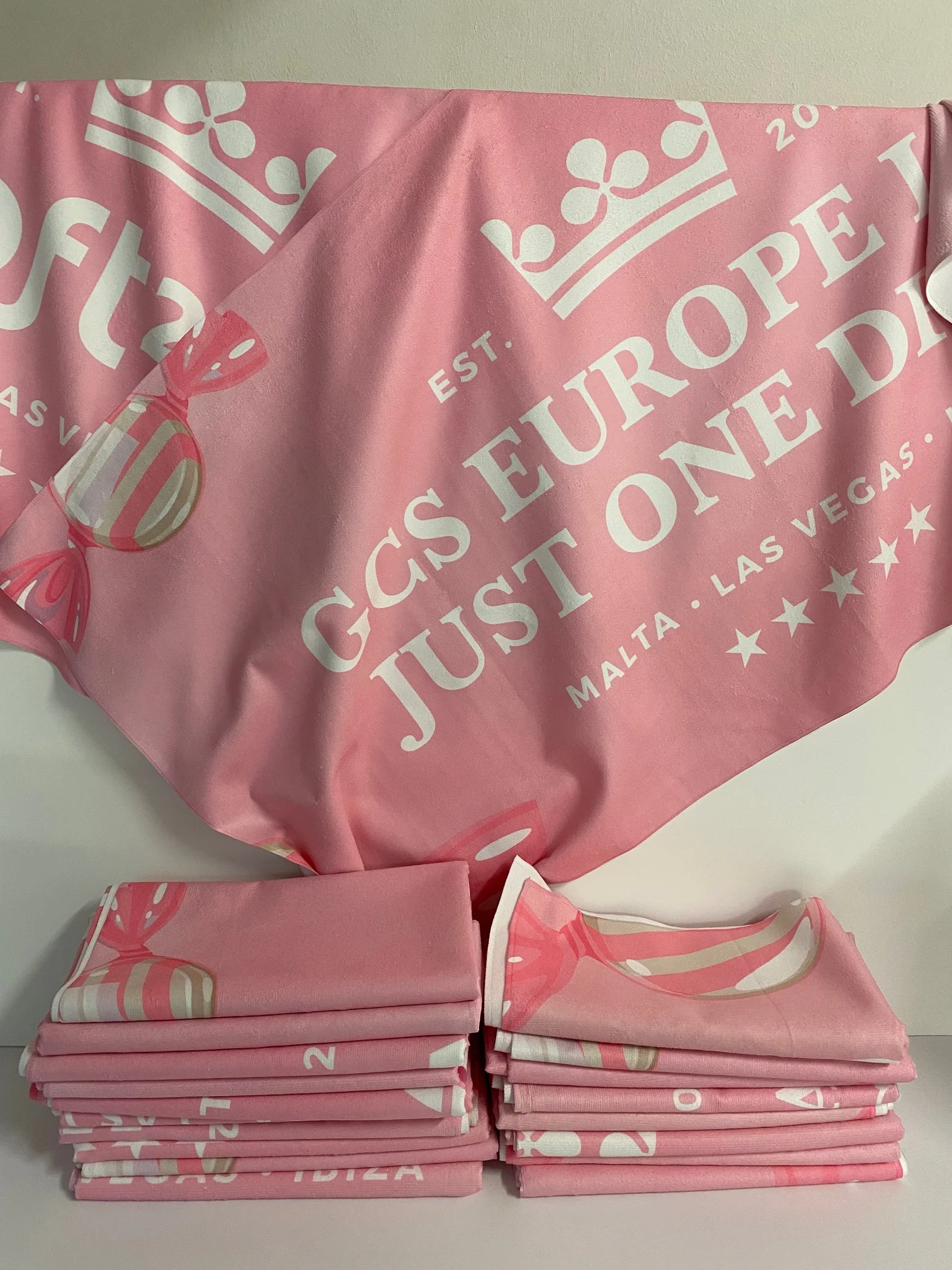 Custom printed towel with white text and graphics, ideal for promotional use.